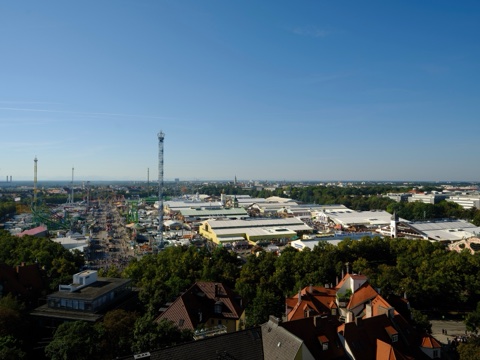 Theresienwiese wide from above, first Saturday 2024 (tent roofs, no logo legible at card size)